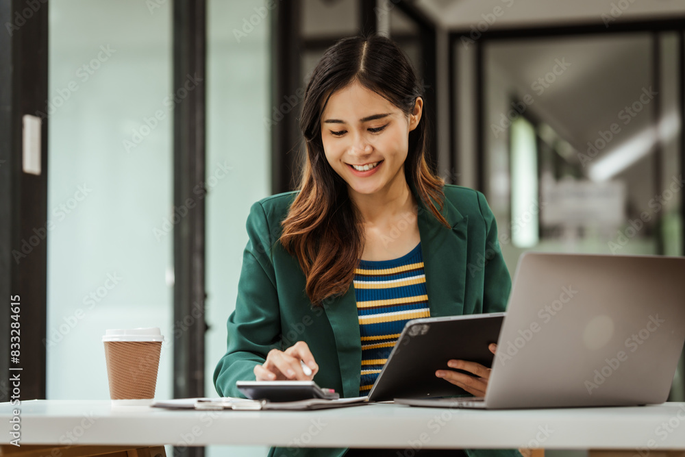 Young woman and other Asian individuals in formal suits working at desks with laptops. They engage in financial tasks including amortization, liquidity analysis, risk assessment, financial modeling. Young woman and other Asian individuals in formal suits working at desks with laptops. They engage in financial tasks including amortization, liquidity analysis, risk assessment, financial modeling.