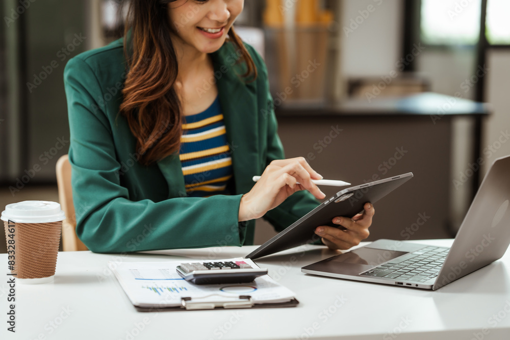 Young woman and other Asian individuals in formal suits working at desks with laptops. They engage in financial tasks including amortization, liquidity analysis, risk assessment, financial modeling. Young woman and other Asian individuals in formal suits working at desks with laptops. They engage in financial tasks including amortization, liquidity analysis, risk assessment, financial modeling.