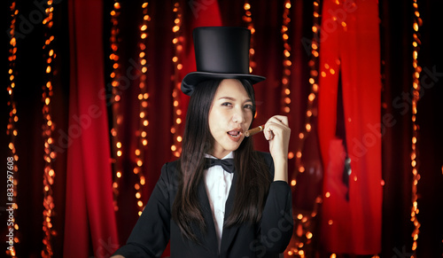 Asain woman with cigar, dressing as tuxedo and highhat on red room decoration photo