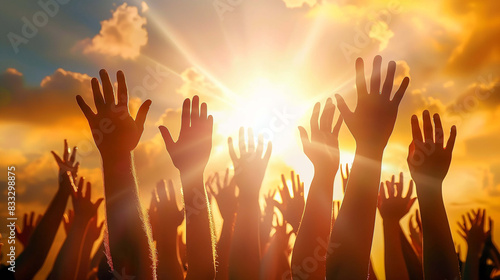 The sun's rays shining brightly behind the raised hands create a powerful sense