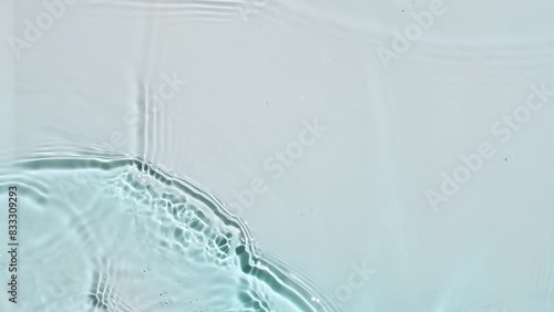 Water surface texture top view. Water waves blue colored. Sun and shadows. Pure blue water with reflections sunlight in slow motion. Motion clean swimming pool ripples and wave. 4k. High quality 
