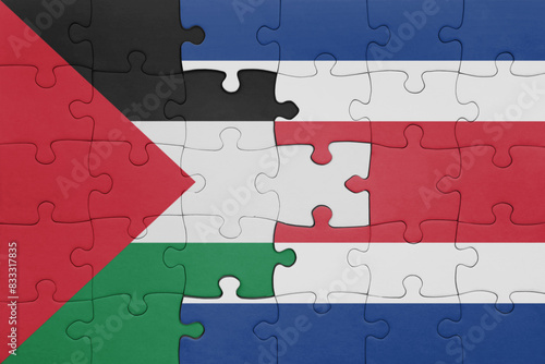 puzzle with the colourful national flag of costa rica and flag of palestine.