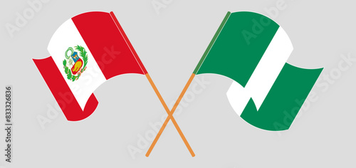 Crossed and waving flags of Peru and Nigeria