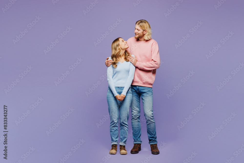 Full body young smiling happy adorable couple two friends family man woman wear pink blue casual clothes together hug cuddle embrace isolated on pastel plain light purple background studio portrait. Full body young smiling happy adorable couple two friends family man woman wear pink blue casual clothes together hug cuddle embrace isolated on pastel plain light purple background studio portrait.