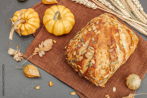 Fresh bread with pumpkin seeds. Home baking concept. Autumn decor