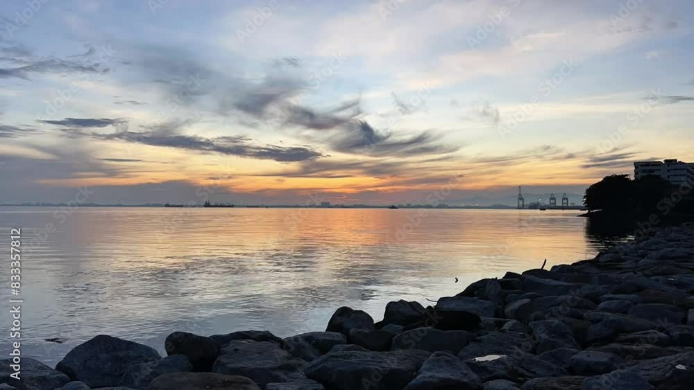Beautiful scenic golden yellow sunrise off the cost over ocean sea water wave early morning cloudy sky time laps Beautiful scenic golden yellow sunrise off the cost over ocean sea water wave early morning cloudy sky time laps