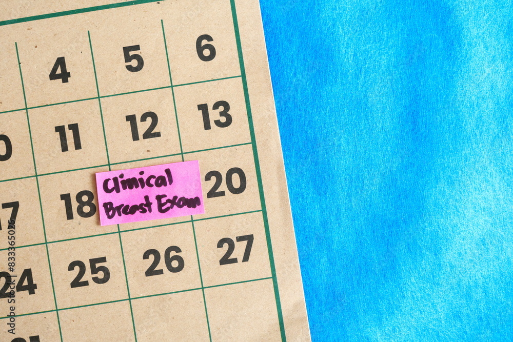 Clinical breast exam or CBE schedule for women concept. Written reminder note on calendar.