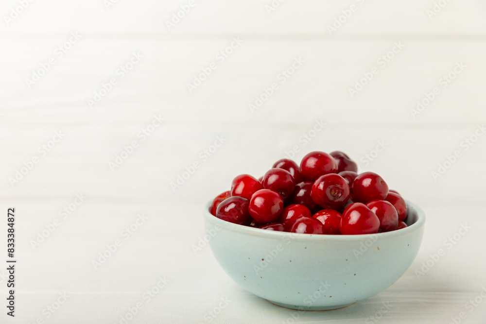 Cherries. Fresh ripe cherries with leaves on a textured wooden background. Fresh sweet organic cherry pile. Berries and fruits. Vegan. Healthy eating. Place for text. Copy space Cherries. Fresh ripe cherries with leaves on a textured wooden background. Fresh sweet organic cherry pile. Berries and fruits. Vegan. Healthy eating. Place for text. Copy space