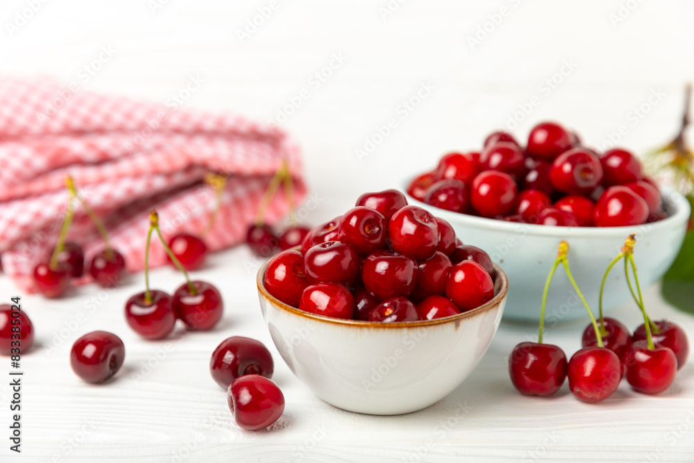 Cherries. Fresh ripe cherries with leaves on a textured wooden background. Fresh sweet organic cherry pile. Berries and fruits. Vegan. Healthy eating. Place for text. Copy space