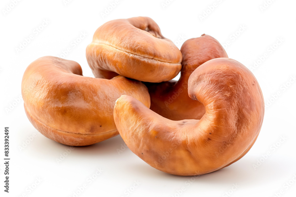 Close-up of shelled and unshelled Cashew nuts isolated on a white background, showcasing their texture Close-up of shelled and unshelled Cashew nuts isolated on a white background, showcasing their texture