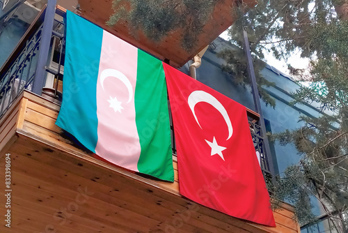 Canvas-taulu The national flags of Azerbaijan and Turkey are hung on the railing of the balcony of the house