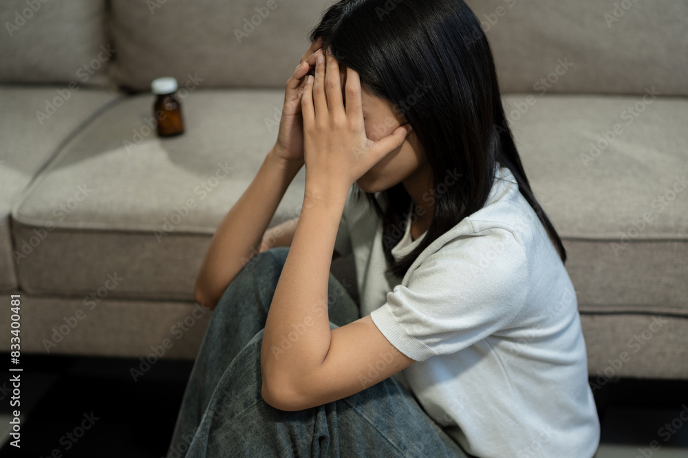 medicine, Sad and depressed young female sitting on the sofa, sad mood, feel tired, lonely and unhappy concept. medicine, Sad and depressed young female sitting on the sofa, sad mood, feel tired, lonely and unhappy concept.