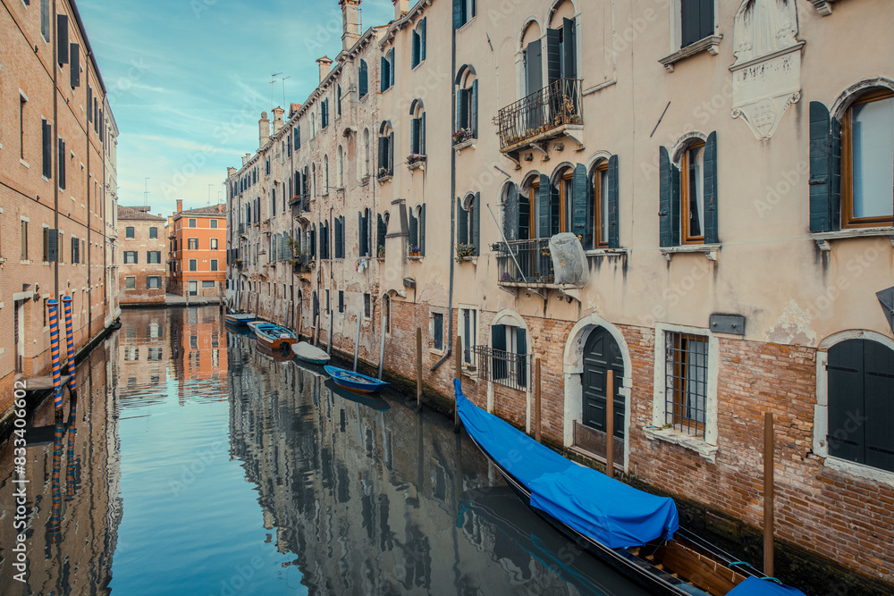 Obraz premium view of venetian canal with blue water and boats