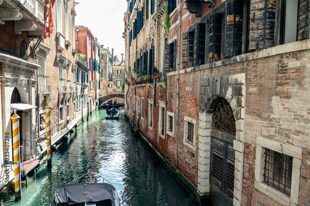Fototapeta premium motorboat moving in narrow venetian canal 