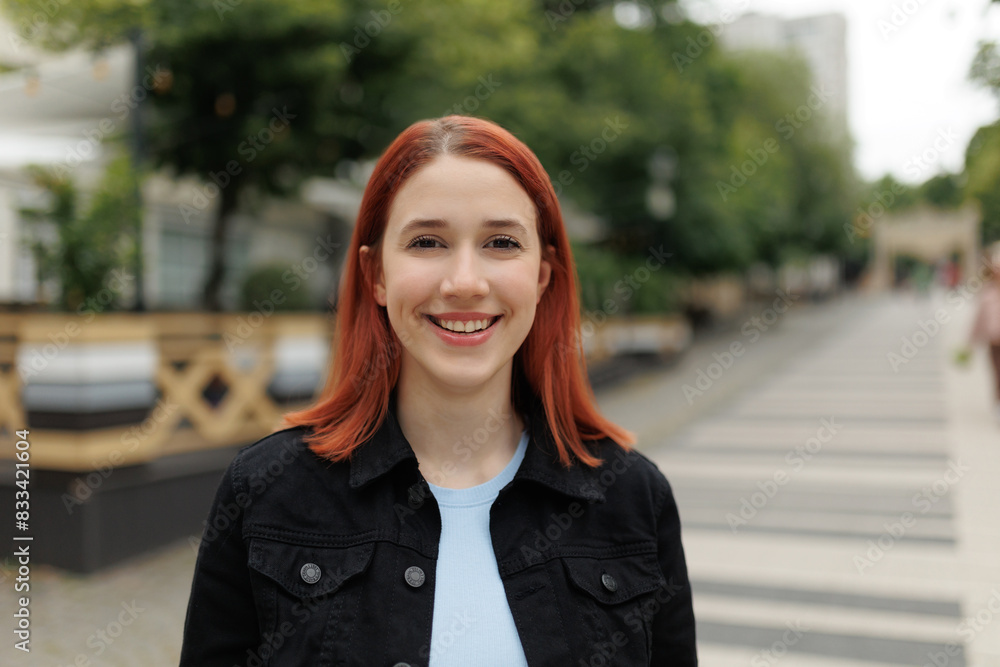 Joyful Red Haired Teenage Girl Posing Happily Outside in the City Joyful Red Haired Teenage Girl Posing Happily Outside in the City
