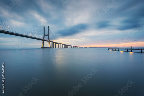 Valokuva Vasco da Gama bridge and pier over tagus river in Lisbon (Portugal), before sunr