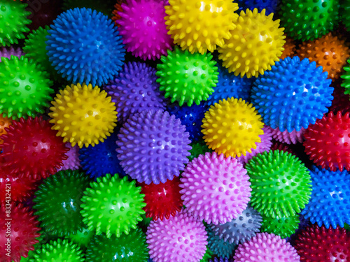 Closeup full-frame background of colorful spiked rubber massage or pet toy balls.