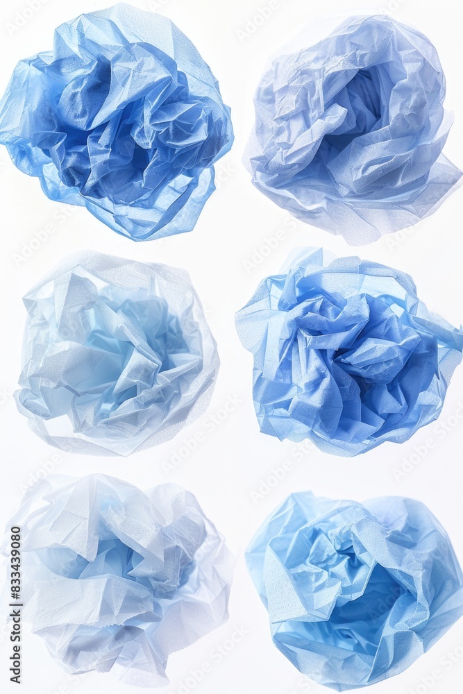 A bunch of blue tissue sitting on a clean white surface, ideal for using as props in photography or videography shoots A bunch of blue tissue sitting on a clean white surface, ideal for using as props in photography or videography shoots