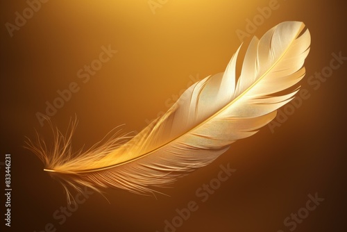 Delicate  golden feather floats gracefully against a soft  glowing amber background