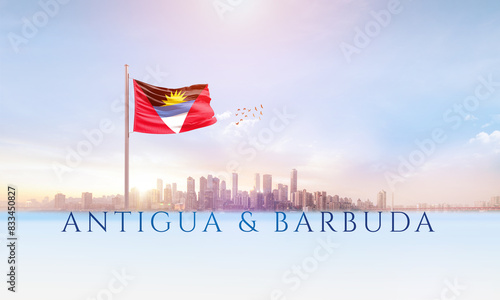 Antigua and Barbuda national flag waving in beautiful building skyline.