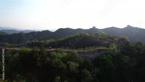 Couple flies a drone over the unrestored Gubeikou section of the Great Wall before sunset photo