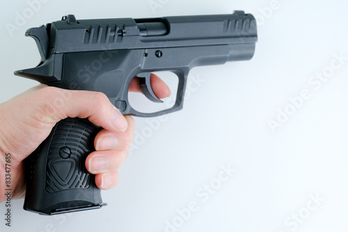 Fotografie An woman holding a gun, ready for action