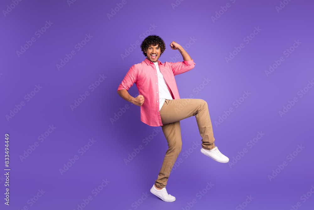 Full size photo of nice young man raise fists wear shirt isolated on violet color background