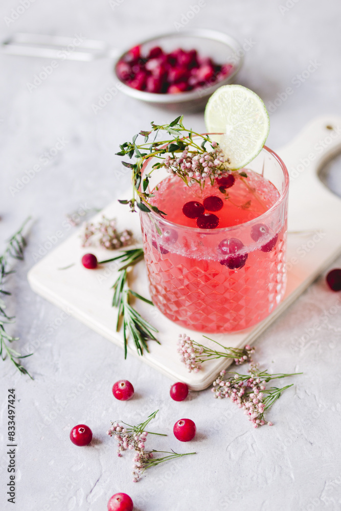 fresh homemade drink with berries and lime on kitchen background