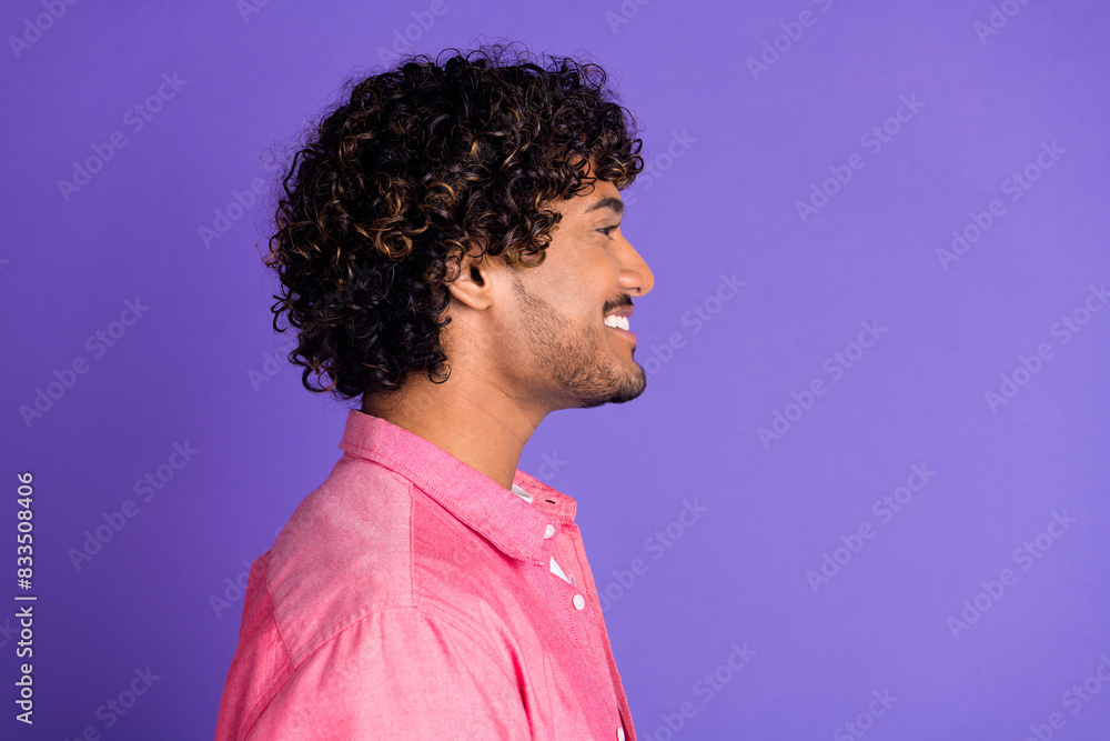 Profile photo of nice young man empty space wear pink shirt isolated on violet color background Profile photo of nice young man empty space wear pink shirt isolated on violet color background