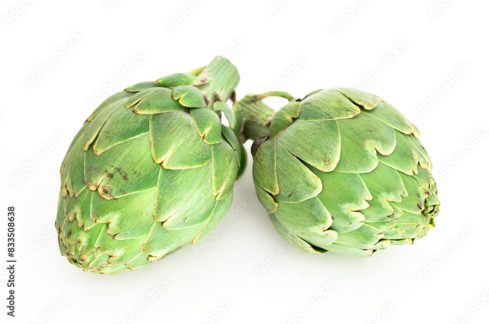 Fototapeta premium Two ripe artichokes on white background