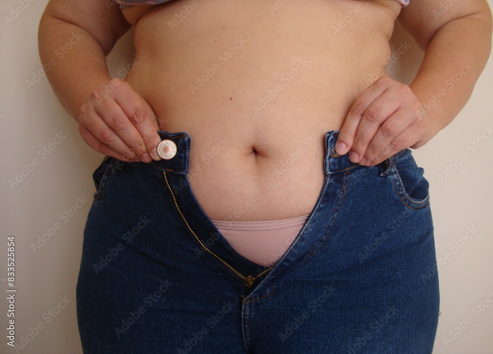 Naklejka premium Overweight belly fat with jeans