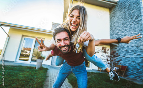 Fotografie Happy young couple holding home keys after buying real estate - Husband and wife