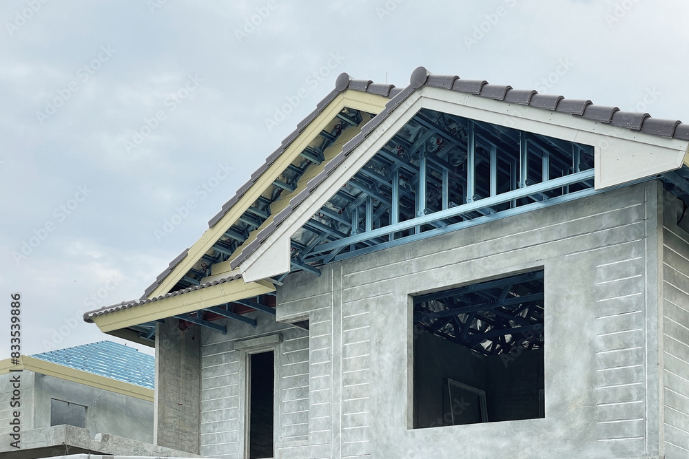 Image of roof structure framework metal under construction for residential project show opening for window and precast wall installation.