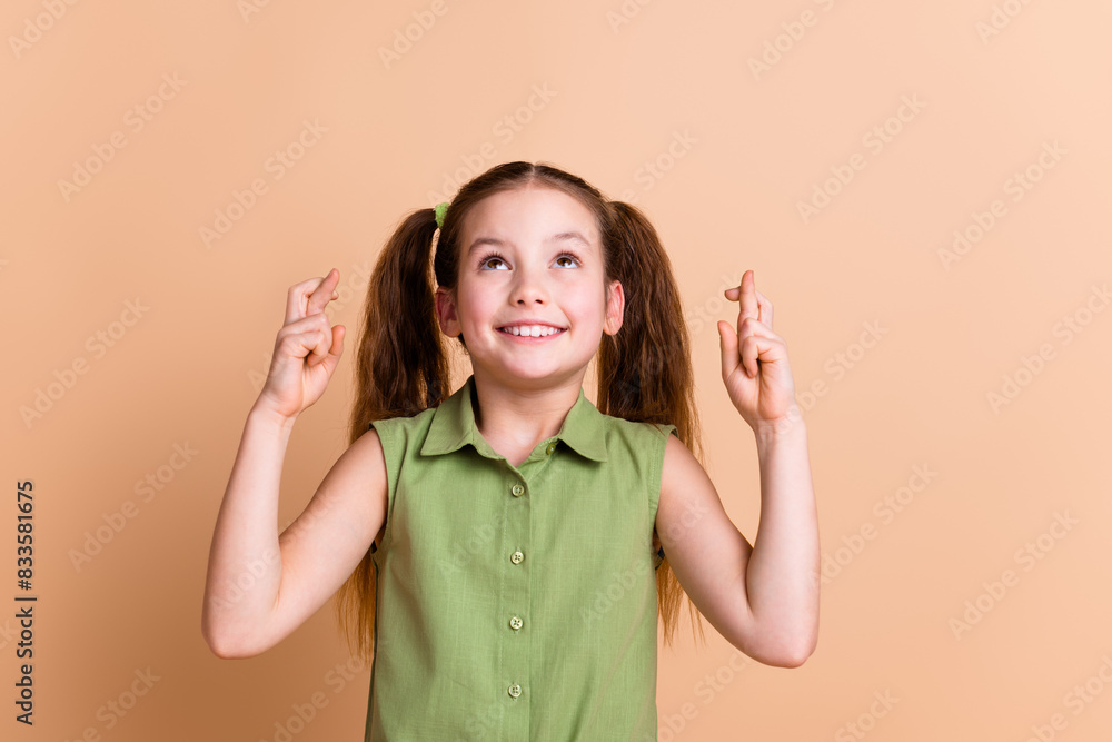 Photo of positive child look up cross fingers dream please isolated pastel color background Photo of positive child look up cross fingers dream please isolated pastel color background