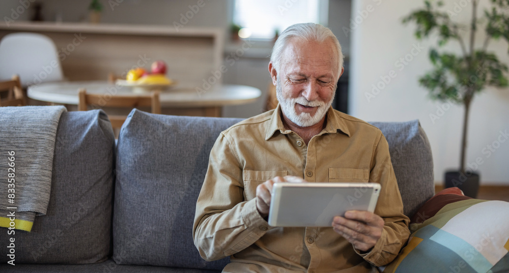 Shot of a mature businessman using a digital tablet in an office. Shot of a mature businessman using a digital tablet in an office.