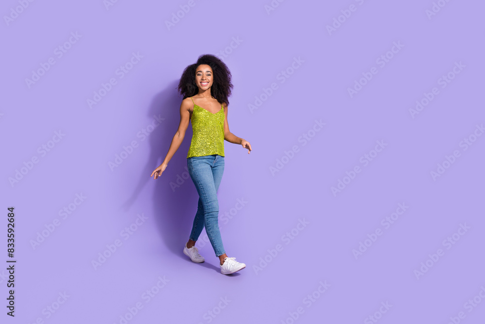 Photo of gorgeous cheerful positive woman wear trendy clothes moving empty space isolated on violet color background
