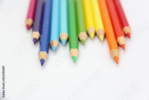 sharpener and colored pencils on a white background