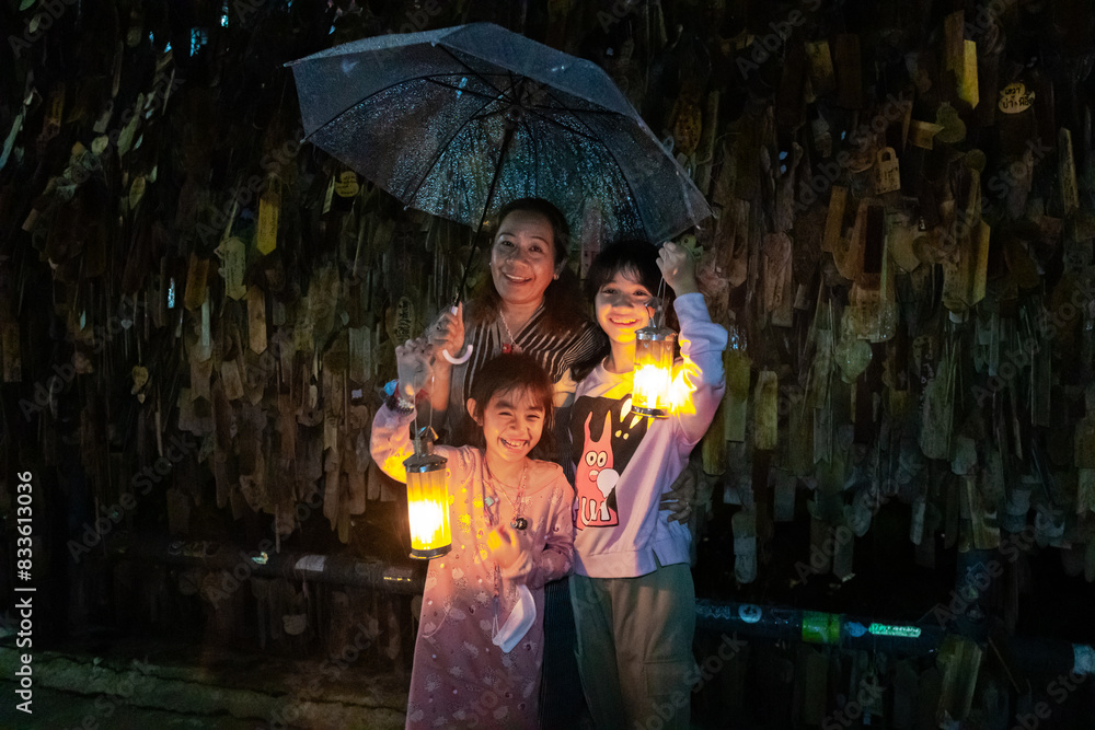 Obraz premium My family with a lamp Night view at Pilok, Kanchanaburi Ban E-Tong in Pilok Thailand