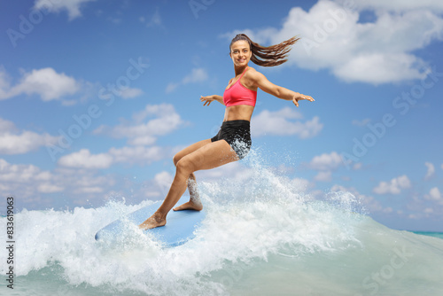 Female surfer riding a surfboard on a wave