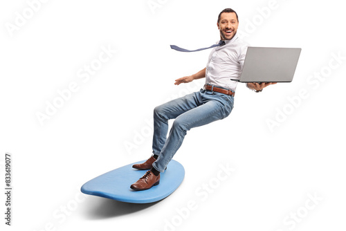 Photography Man holding a laptop computer and riding a surfboard