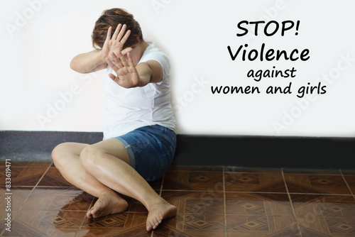 Cuadro en lienzo Woman sits on the floor, feeling of scary, make hand gesture to stop