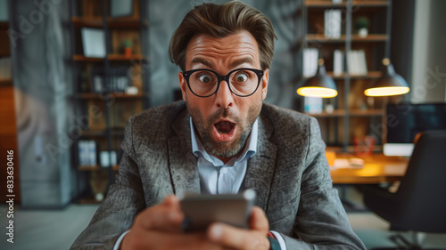Surprised Businessman Reacting to Shocking News on Smartphone