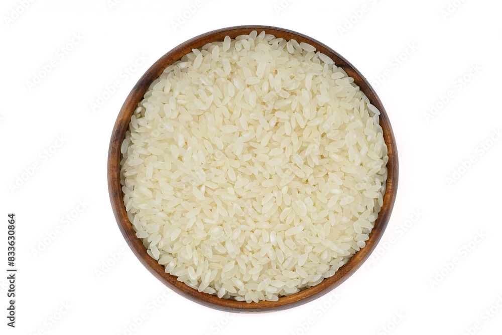 Raw white rice on wooden background. Long uncooked rice in wooden plate. Natural organic food. Traditional Asian cereal culture. Raw white rice on wooden background. Long uncooked rice in wooden plate. Natural organic food. Traditional Asian cereal culture.