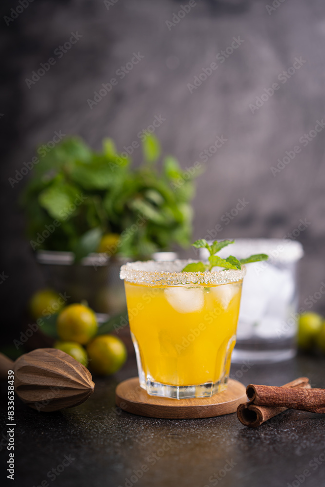 Fototapeta premium Fresh summer orange mojito with tangerine orange, mint and ice on black background