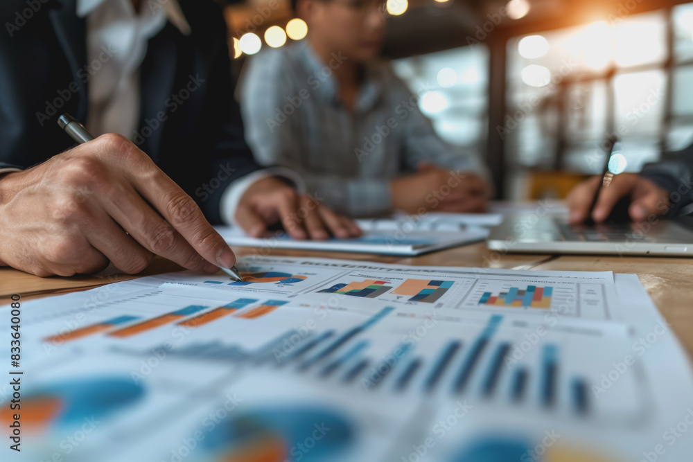 Business team meeting to analyze data charts for marketing plans and office profits. Business team meeting to analyze data charts for marketing plans and office profits.