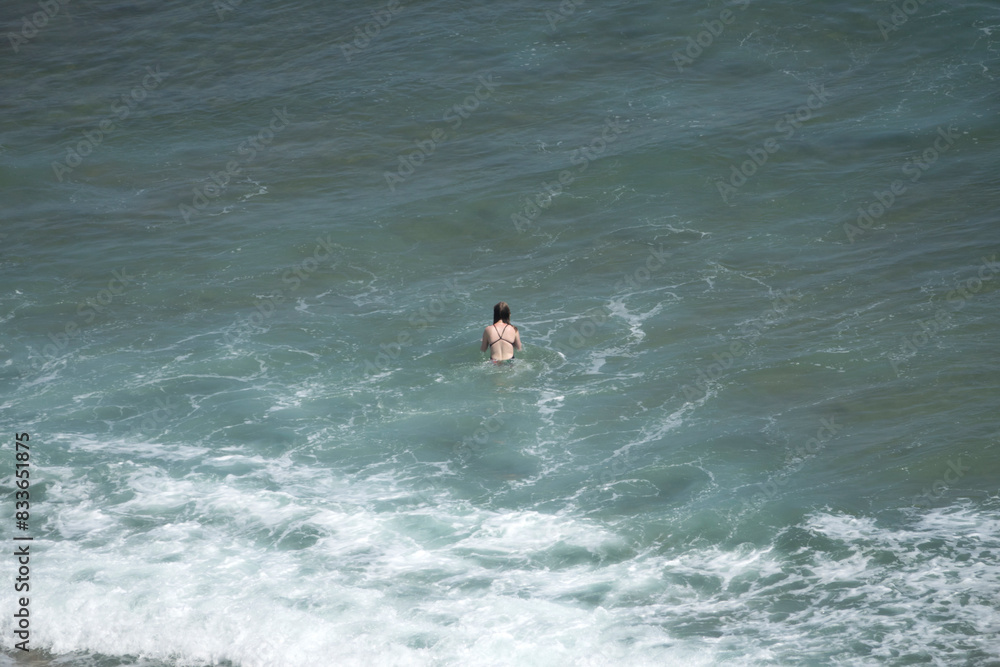 View of a woman in the surf, enjoying swimming