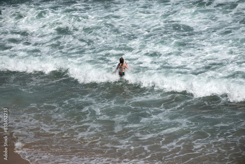 View of a woman in the surf, enjoying swimming © 안구정화