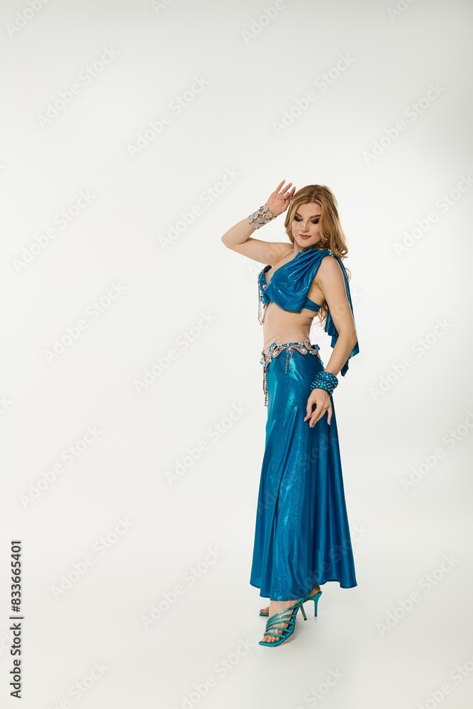 Graceful woman in a blue dress striking a pose. Graceful woman in a blue dress striking a pose.