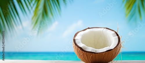 A tantalizing copy space image showcasing a whole ripe coconut against a vibrant backdrop