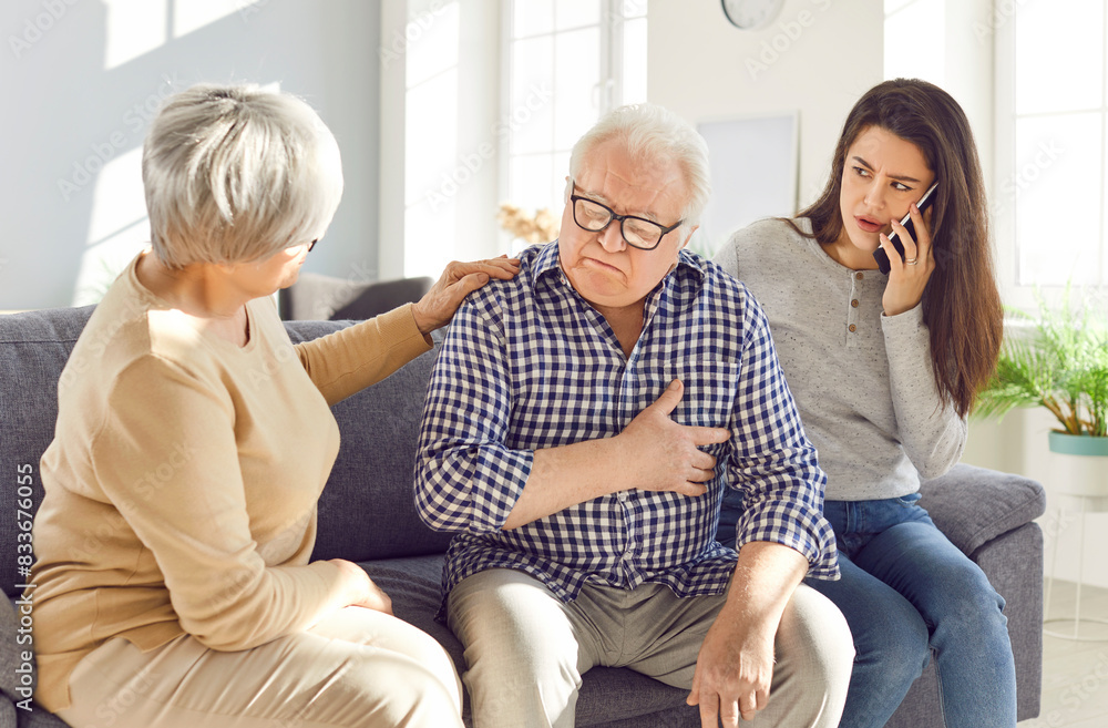 Family calls an ambulance for father experiencing a heart attack or heart disease at home. This emergency situation requires immediate aid, and they quickly use the phone to seek help. Family calls an ambulance for father experiencing a heart attack or heart disease at home. This emergency situation requires immediate aid, and they quickly use the phone to seek help.